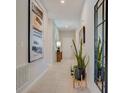 Bright and airy entryway with tile flooring, modern art, and a full-length mirror at 12922 Trovita Dr, Grand Island, FL 32735