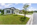 This single-story house features a well-maintained lawn and a paved driveway at 6316 Dolostone Dr, Lakeland, FL 33811