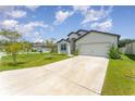 This lovely home boasts a welcoming front porch and two-car garage at 6316 Dolostone Dr, Lakeland, FL 33811