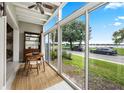 Bright sunroom with lake view and seating area at 151 N Orlando Ave # 131, Winter Park, FL 32789