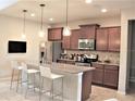 Kitchen with granite countertops and brown cabinets at 9054 Rhodes St, Kissimmee, FL 34747