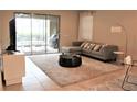 Living room with gray sectional sofa and access to patio at 9054 Rhodes St, Kissimmee, FL 34747
