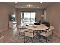 Dining area with white round table and access to the patio at 9054 Rhodes St, Kissimmee, FL 34747