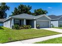 Gray house with two-car garage and well-manicured lawn at 3882 Willow Ridge Dr, Lakeland, FL 33810