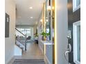 Bright and spacious entryway with modern light fixtures and a stylish console table at 1692 Tropical Palms Cir, Kissimmee, FL 34747