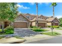 Townhouses with stone accents and brown double doors garage at 10747 Belfry Cir, Orlando, FL 32832