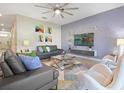 Open living room featuring a TV and accent wall at 1585 Mulligan Blvd, Davenport, FL 33896