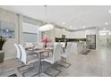 Bright dining room with a large table and modern chandelier at 1585 Mulligan Blvd, Davenport, FL 33896