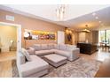 Open concept living room with a sectional sofa and a modern kitchen at 7487 Brooklyn Dr, Kissimmee, FL 34747