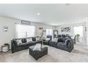 Spacious living room with sectional sofa and large windows at 1839 Wild Rye Way, Kissimmee, FL 34744