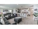 Open kitchen with island, white cabinets, and stainless steel appliances at 1839 Wild Rye Way, Kissimmee, FL 34744