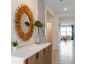 Bright and spacious entryway with decorative mirror and console table at 3863 Malawi Trl, Saint Cloud, FL 34772