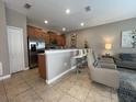 Modern kitchen with stainless steel appliances and breakfast bar at 2937 Banana Palm Dr, Kissimmee, FL 34747
