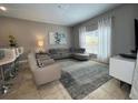 Living room with comfortable seating and access to kitchen and dining areas at 2937 Banana Palm Dr, Kissimmee, FL 34747
