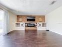 Living room with brick fireplace and dark floors at 33 S Ortman Dr, Orlando, FL 32805