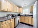 Kitchen with light wood cabinets and granite counters at 33 S Ortman Dr, Orlando, FL 32805
