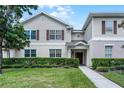 Two-story townhome with landscaping and walkway at 2521 Old Kent Cir # West, Kissimmee, FL 34758