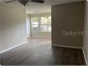 Living room with neutral walls, new flooring, and a ceiling fan at 5164 Conroy Rd # 1514, Orlando, FL 32811