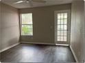 Bright bedroom with new flooring and a sliding glass door at 5164 Conroy Rd # 1514, Orlando, FL 32811