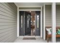Inviting front entrance with a dark door and wreath, leading into the home at 301 Richard Pl, Orlando, FL 32806