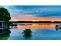 Stunning lake view at sunset with a dock at 301 Richard Pl, Orlando, FL 32806
