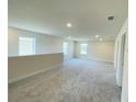 Spacious loft area with carpeted floor, recessed lighting, and multiple windows at 4379 Sagefield Dr, St Cloud, FL 34773
