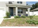 Landscaped front yard with flowers and plants near the house entrance at 1186 August Sky Dr, Deltona, FL 32738