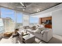 Open concept living room with a sectional sofa and city views at 155 S Court Ave # 2208, Orlando, FL 32801