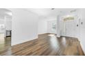 Bright and airy living room with wood-look floors at 3404 Great Pond Dr, Kissimmee, FL 34746