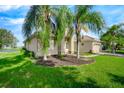 Home exterior showcasing landscaping and a golf course view at 3404 Great Pond Dr, Kissimmee, FL 34746