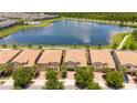 Aerial view of community, lake, and several homes with tile roofs at 8841 Rhodes St, Kissimmee, FL 34747