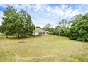 Spacious backyard with a fire pit and large grassy area at 24714 Martin St, Eustis, FL 32736
