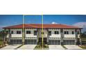 Three-unit townhome building with modern design and attached garages at 1815 Brentwood Ct, Davenport, FL 33837