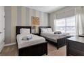 Bedroom with two twin beds and a shared bathroom at 4838 Romeo Cir, Kissimmee, FL 34746