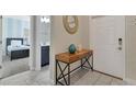 Bright entryway with tile flooring and a console table at 4838 Romeo Cir, Kissimmee, FL 34746