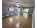 Open living area with tile floors, access to screened porch, and kitchen passthrough at 1123 Spring Meadow Dr # 1123, Kissimmee, FL 34741
