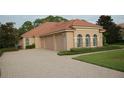 One-story home with tile roof, three car garage and landscaped yard at 136 Osprey Hammock Trl, Sanford, FL 32771