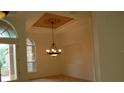 Elegant dining room with chandelier and arched windows at 136 Osprey Hammock Trl, Sanford, FL 32771