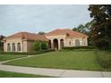 One-story home with tile roof, arched entryway, and landscaped yard at 136 Osprey Hammock Trl, Sanford, FL 32771