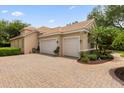 Two-car garage with paver driveway and landscaping at 277 Olivia Rose Ct, Lake Mary, FL 32746