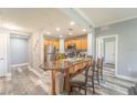 Modern kitchen with granite island and wood cabinets at 7673 Heritage Crossing Way # 101, Reunion, FL 34747