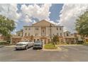 Condo building exterior with parking at 7673 Heritage Crossing Way # 101, Reunion, FL 34747