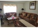 Living room with brown sofas, coffee table, and decorative pillows at 713 W 2Nd St, Lakeland, FL 33805
