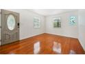 Bright living room with hardwood floors and stained-glass window at 1338 Vassar St, Orlando, FL 32804