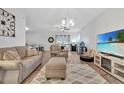 Living room with sectional sofa, recliner, and TV at 1624 Hawksbill Ln, Saint Cloud, FL 34771