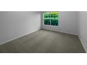 Bright bedroom with carpeted floors and a large window at 2323 Arbor Lakes Cir # 2323, Sanford, FL 32771