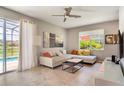 Spacious living room with sectional sofa, large window, and access to a patio at 491 Las Fuentes Dr, Kissimmee, FL 34746