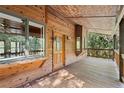 Wooden porch with a wooden door and window at 1205 Sutton Trl, Geneva, FL 32732