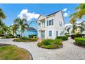 Charming two-story home with a patio and walkway, surrounded by lush landscaping at 8024 Surf St, Kissimmee, FL 34747