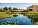Aerial view of community with lake, lush landscaping, and townhomes at 17401 Serenidad Blvd, Clermont, FL 34714